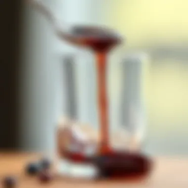 A spoonful of mulberry molasses drizzling into a glass, emphasizing its viscosity