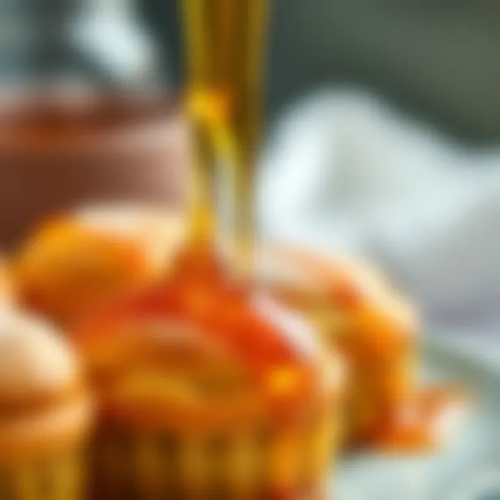 Close-up of a rich, golden syrup drizzling over pastries